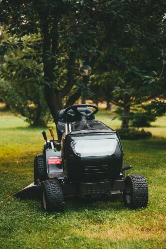 Commercial riding mower on a landscaped lawn